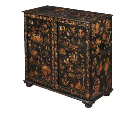 Y A VICTORIAN BLACK-PAINTED AND DECOUPAGE SIDE CABINETCIRCA 1880The interior divided with an arrangement of pigeon-holes, the