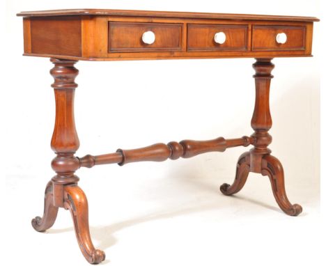 A 19th century Victorian mahogany writing desk / ladies writing table. The table of a rectangular form with shaped edges and 