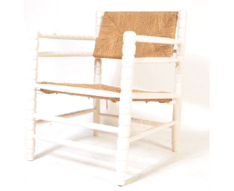 An early 20th century circa 1920’s gipsy style fireside armchair / easy chair. The chair having envelope rush seat and backre