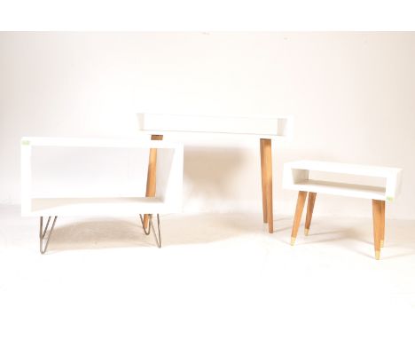 A collection of three modern minimalist melamine side table / hall table / console table / media units. The units are raised 