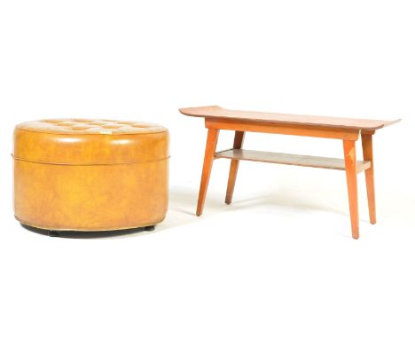 A retro vintage circa 1970s teak wood coffee table having curved edges raised on angular tapering supports united by a magazi