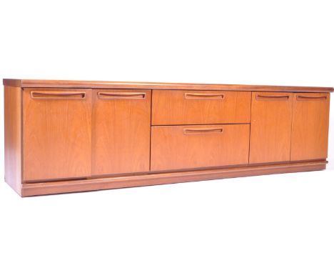 Meredew - British Modern Design - A retro vintage teak wood sideboard credenza having a chamfered top atop a central bank of 