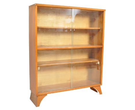 A vintage retro 20th century teak wood bookcase / display cabinet by Herbert Gibbs. The cabinet having sliding glass doors ra