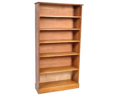 A retro vintage late 20th century teak wood open fronted bookcase of upright form having a bank of seven shelves. Measures: 2