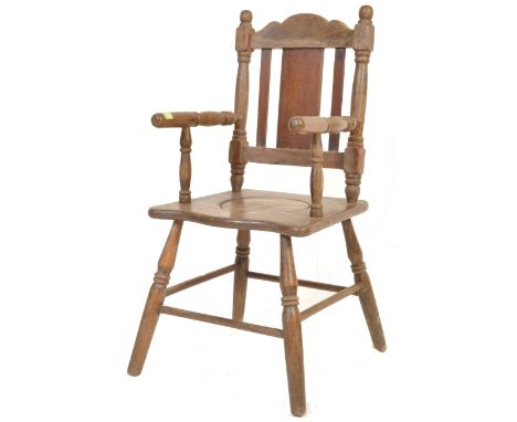 A 19th century Victorian mahogany children chair / commode chair having curved top rail with turned spindle backrest raised o