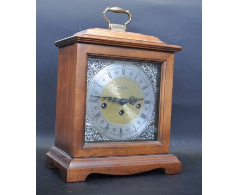 A vintage retro mid 20th century Howard Miller clock / mantel clock. The clock having a silver dial with Roman numerals to th