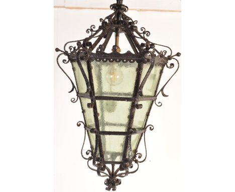 An early 20th century circa 1910’s cast iron blacksmith porch lantern / lamp. The lathers of a hexagonal form with tapered bo