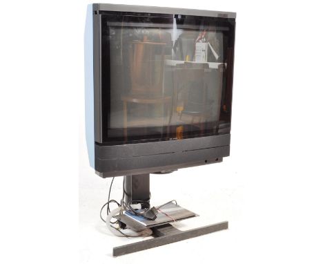 An early 21st century Bang &amp; Olufsen Beovision MX8000 television / TV having a 25" screen with instruction manual and CD 
