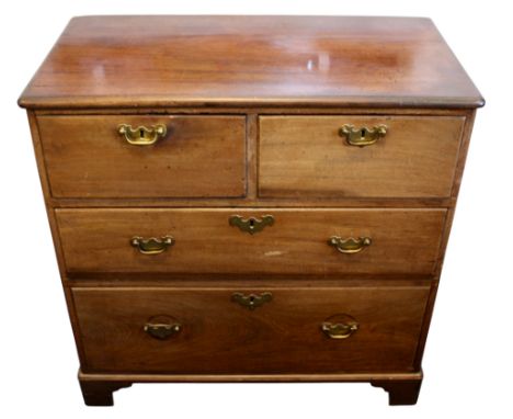 A Georgian Mahogany Chest of Drawers of solid construction, fitted with two short and two long drawers, standing on bracket f