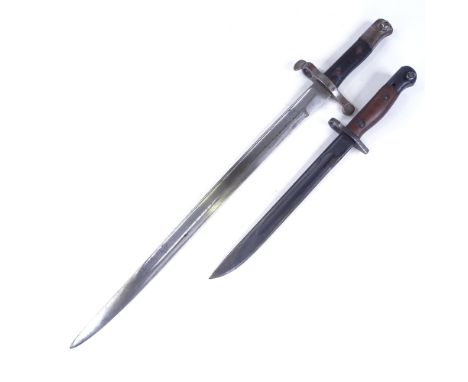 A First War Period sword bayonet with metal scabbard, and another bayonet and scabbard (2) 