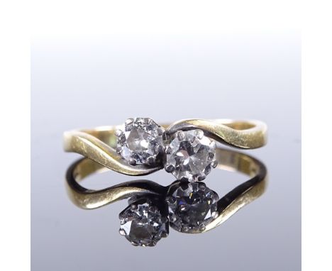 A late 20th century 18ct gold 2-stone diamond cross-over ring, total diamond content approx 0.6ct, setting height 6mm, size R