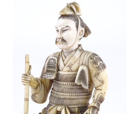 A Japanese ivory carving of a Samurai Warrior, Meiji Period, signed with lacquer seal under base, height 22cmThe item that th