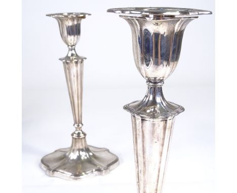 A pair of George V silver table candlesticks, shaped oval form with tapered stick, reeded border and removable sconces, by Go