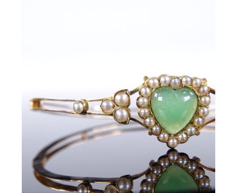 A Victorian unmarked gold green stone and pearl heart-shaped hinged bangle, with openwork body, internal diameter 58mm, inter