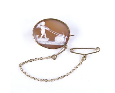 A 19th century relief carved shell cameo panel brooch, depicting cherub being pulled by 2 snails, in unmarked gold frame, bro