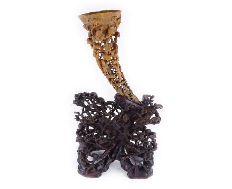 A 19th century Chinese rhinoceros / rhino horn full tip cup, carved and pierced all over with Oriental figures, exotic birds 