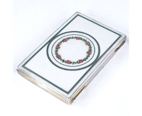 A small early 20th century Continental rectangular silver and enamel cigarette case, hand painted floral decoration with engi
