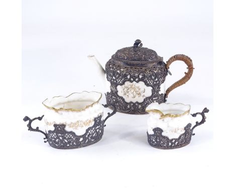 A Victorian silver-cased 3-piece ceramic tea set, pierced and embossed silver mounts, by William Comyns, hallmarks London 189