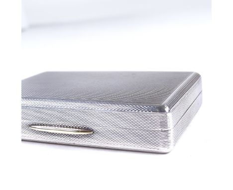 An Elizabeth II rectangular silver snuffbox, allover engine turned decoration, with yellow metal thumbpiece and gilt interior