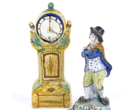 A 19th century Pearlware pottery figure, man wearing a cloak, height 20cm, and a Pratt Ware pottery ornamental longcase clock