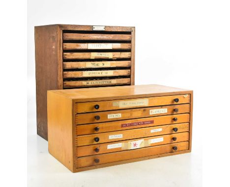 BOOKBINDING; a collection of metal typeface blocks in two cabinets, the first with twelve trays, ten enclosing various design
