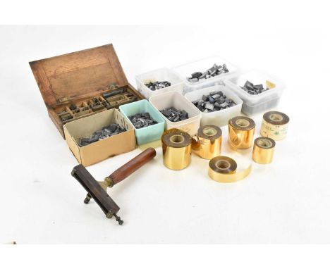 BOOKBINDING; an oak box containing various gold leaf spacers in various designs, with six rolls of foil, a bookbinders hand t