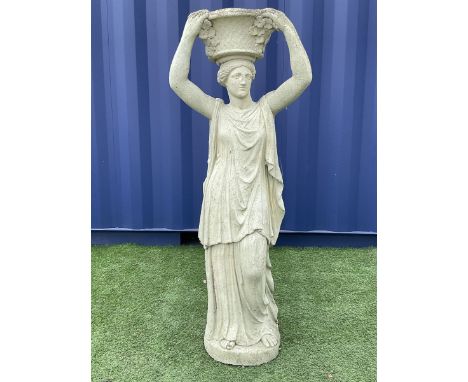 Composite stone classical figure of a woman with raised basket planter, decorated with flower headsDimensions: Height:&nbsp;1