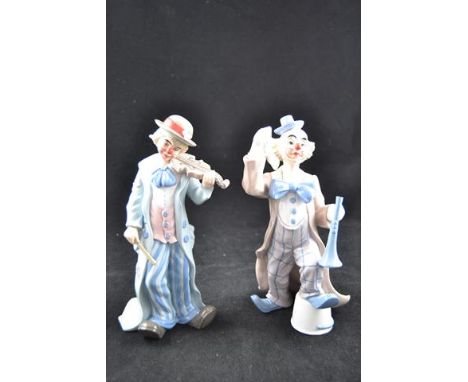 Two Lladro porcelain figures - clown playing violin, H23.5cm, and clown with trumpet, H22.5cm, both with blue printed marks t