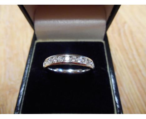 A 9ct white gold half eternity ring with thirteen channel set diamonds -  size M 1/2, approx gross weight 3.4g.CONDITION REPO