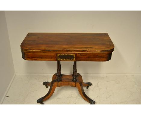 An early 19th century brass inlaid rosewood card table, quadruple column supports, brass paw feet - H74cm, W91cm, D46cmCONDIT