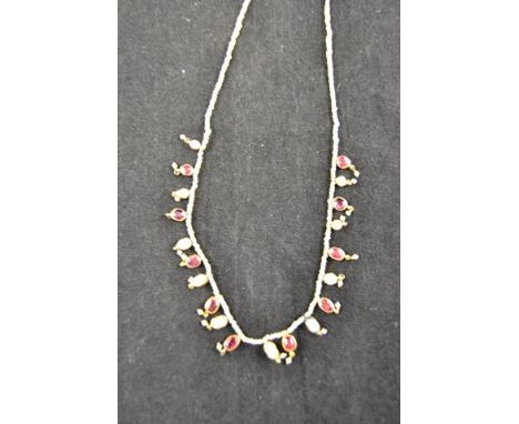 A seed pearl necklace with fringe of irregular shaped pearls and red spinels in yellow metal mounts - L38.5cm.CONDITION REPOR