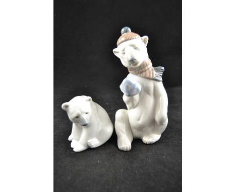 Two Lladro porcelain figures - polar bear wearing hat and scarf, H18cm; seated naturalistic polar bear, H9cm, both with blue 