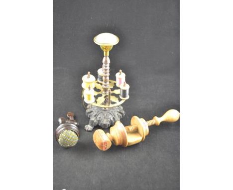 A Victorian cast iron and brass cotton reel stand, together with two pin cushion clamps.CONDITION REPORTcotton reel stand wit