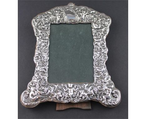 A silver photograph frame, by Ray Hall, Birmingham 1996, for a rectangular portrait, the frame repousse cherubs, flowers and 