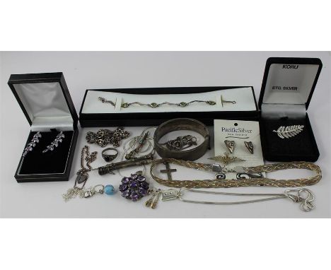 A collection of silver jewellery, to include; a sterling silver rhodium plated flower brooch, in box, a hallmarked silver ban