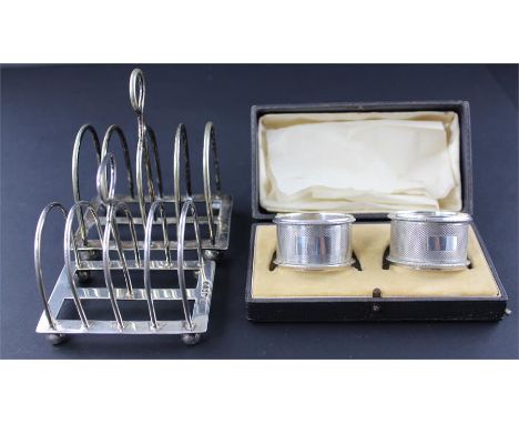 A pair of cased silver napkin rings, by John Thompson &amp; Sons, Birmingham 1935/6, of circular form, having engine turned d