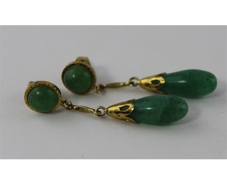 A pair of apple green jade drop earrings, having yellow metal set circular green jade cabochon suspending bar and tulip mount