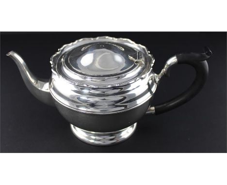 A silver tea pot, by Mappin &amp; Webb, Birmingham 1923, of circular form with ebony loop handle with scroll shoulder and car