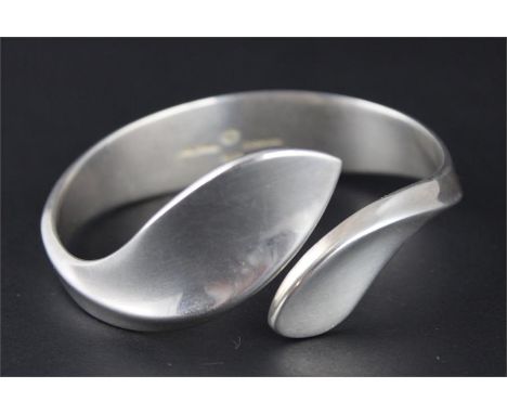 A Georg Jensen silver bangle, designed by Hans Hansen, impressed Georg Jensen and Hans Hansen logos, "Danmark 925S", "G.J Ld"