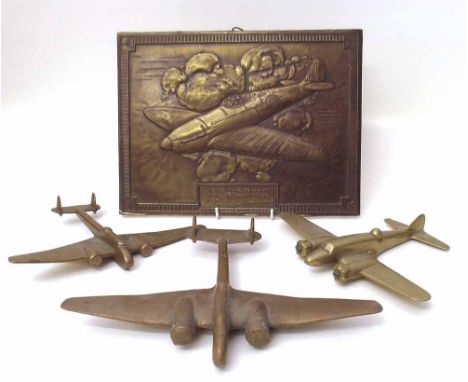 Three brass trench art / apprentice piece models of twin engine aircraft and a Winston Churchill / Battle of Britain plaque. 
