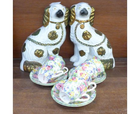 A pair of Staffordshire spaniels and Brama chintz cups and saucers, one cup chipped 