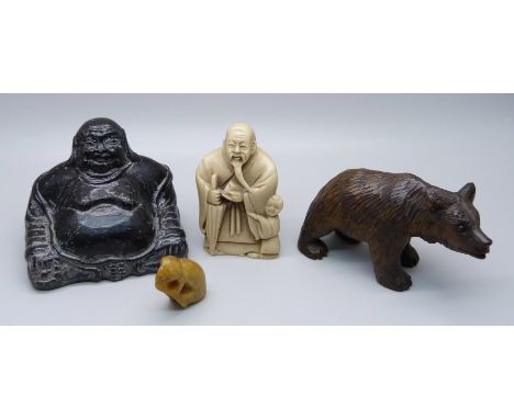 A carved Black Forest bear, a Buddha figure, a resin netsuke and a small carved figure 