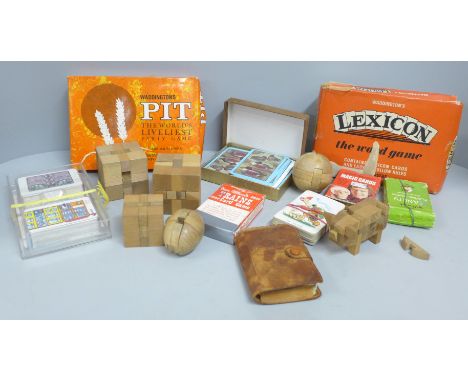 A collection playing cards, card games and wooden puzzles 