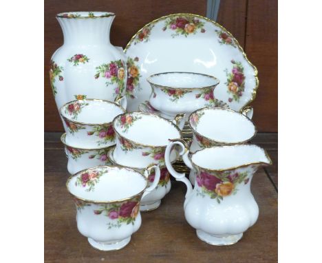 Royal Albert Old Country Roses; seven cups and saucers, five tea plates, bread and butter plate, cream and sugar and vase, on