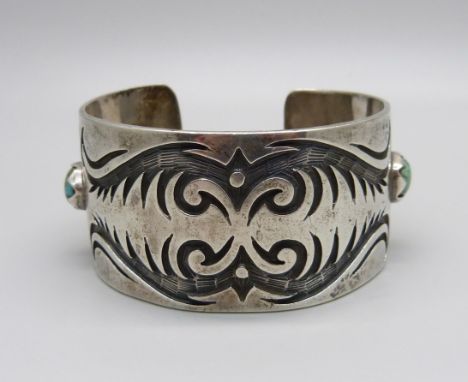 A silver and stone set bangle, marked sterling, Navajo style 