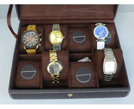 Five wristwatches including Timex, in a watch display box 