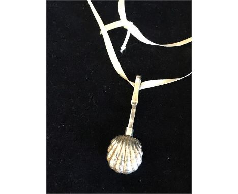 A silver shell style necklace on ribbon