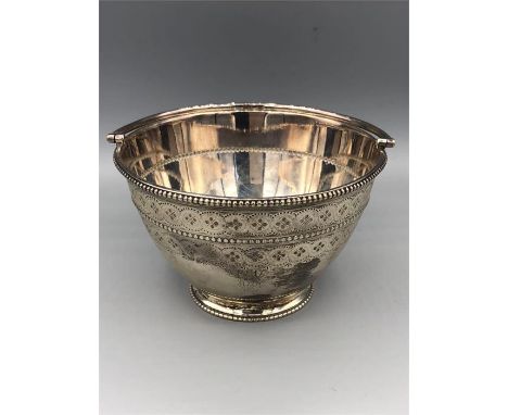 A silver bonbon dish with handle, marked 1874