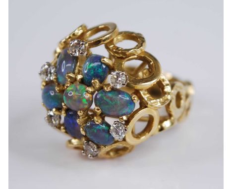 An 18ct yellow gold, opal and diamond bombe cluster ring, comprising seven opal cabochons interspersed with six round brillia