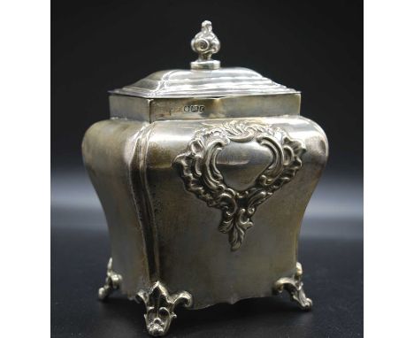 A late Victorian silver tea caddy, of shaped shouldered rectangular form with lift-off cover, having repousse decorative cart
